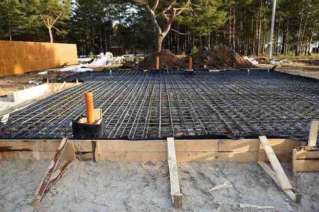 Concrete slab preparation with steel rebar reinforcement grid before pouring foundation in Medina, OH